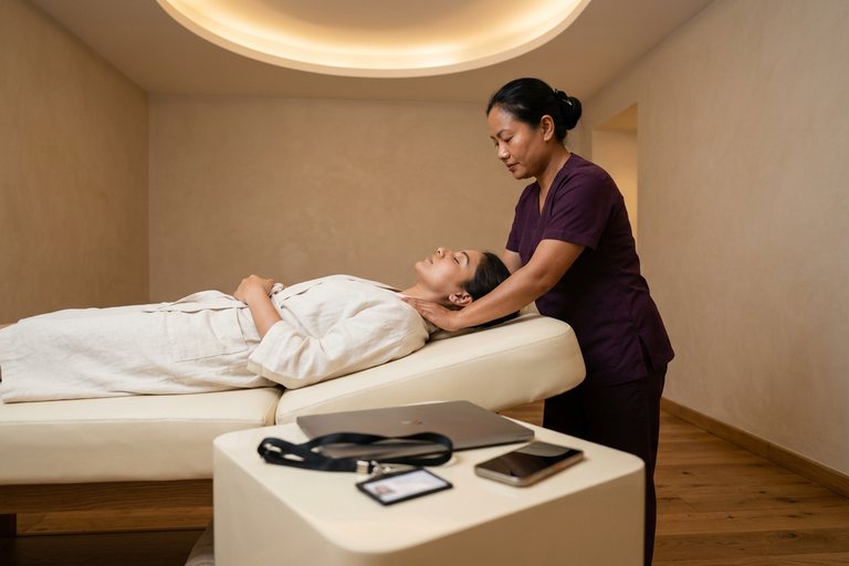 Neck and shoulder massage with a laptop and lanyard set aside