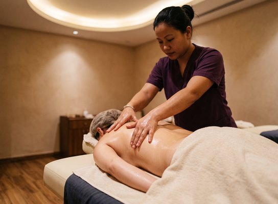 Therapist performing a Swedish massage with long flowing strokes